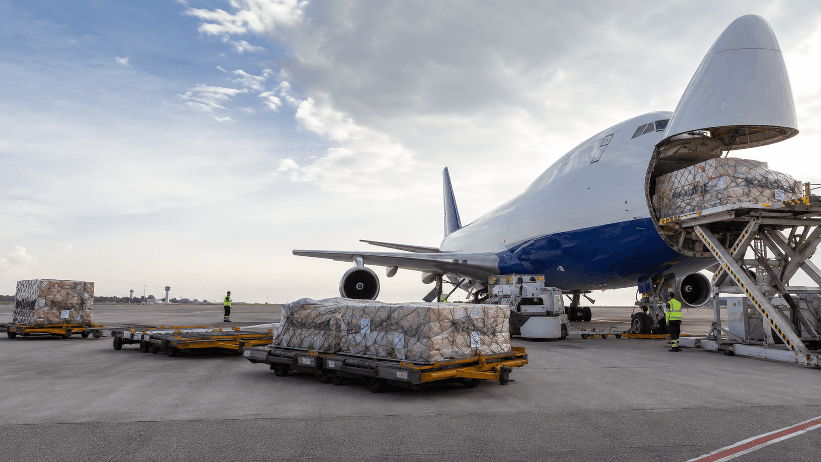 Air freight cargo plane being loaded at sunset